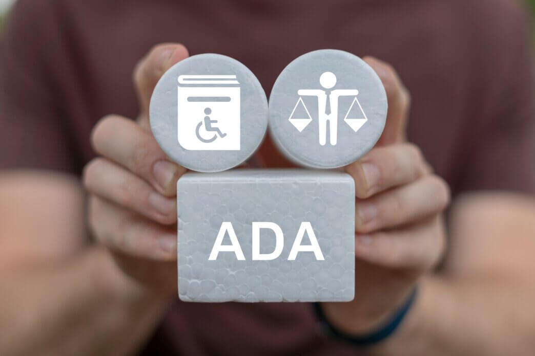 ADA compliance features for WordPress. Man holding blocks with ADA, legal and handbook
