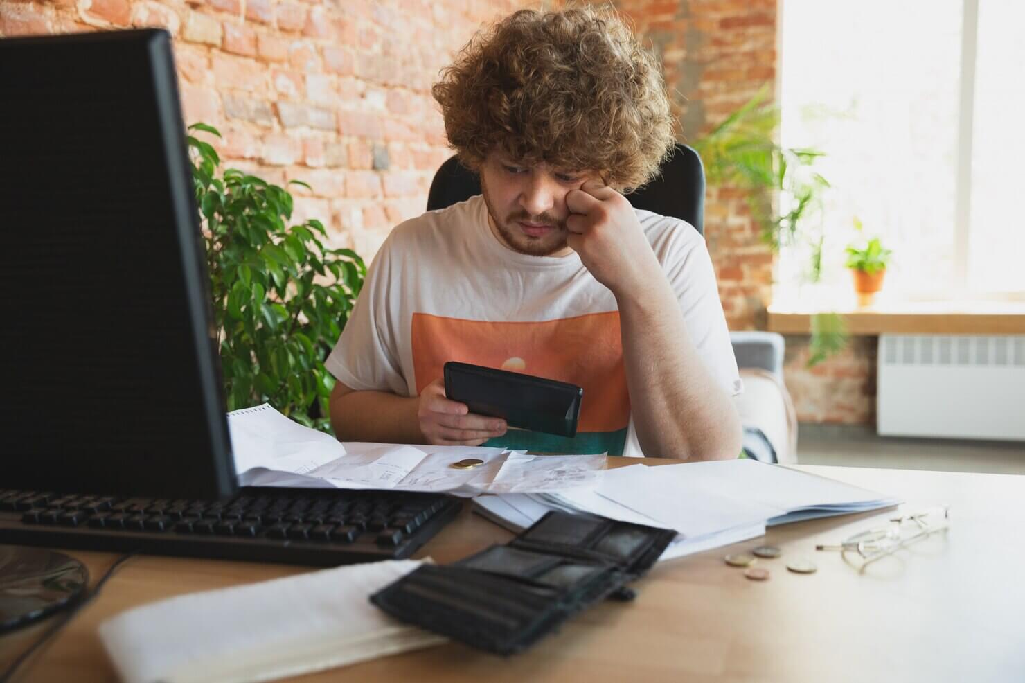Business man calculating budget from website fixes and redesign