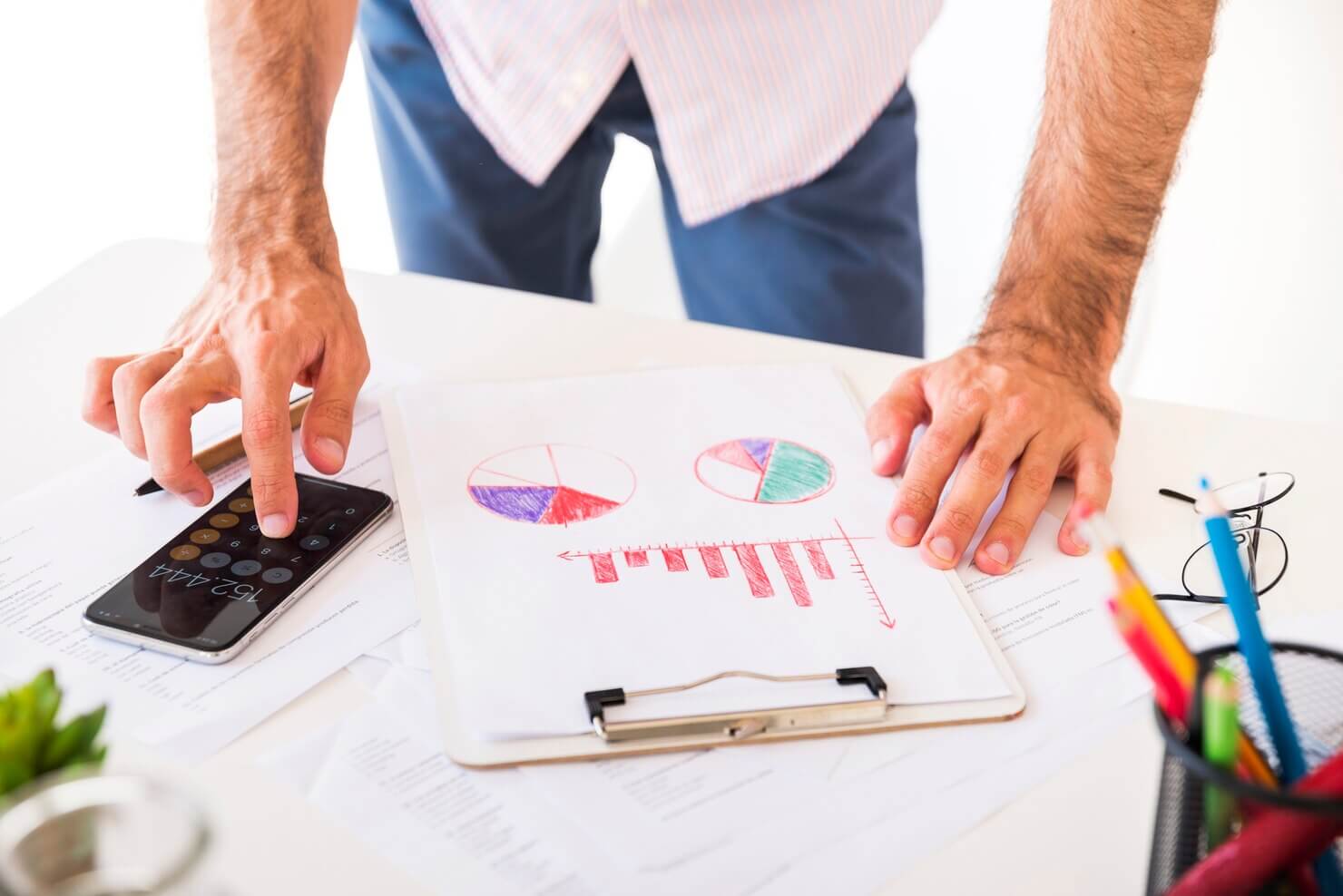 Business man working in a office calculating the cost-effectivness of WordPress development strategies for marketing and advertising agencies