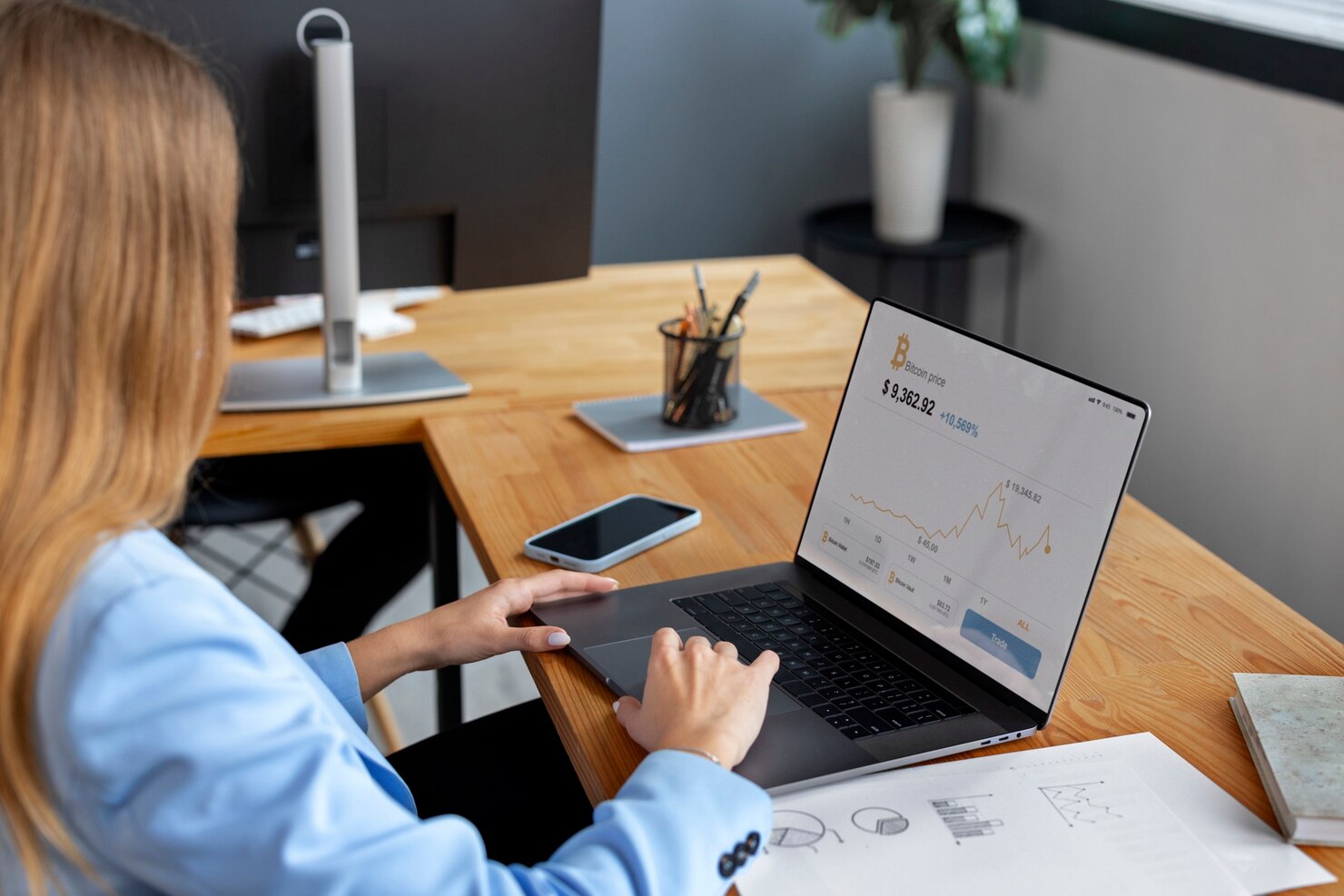 Business person looking at finance graphs on financial services websites that were created via WordPress development