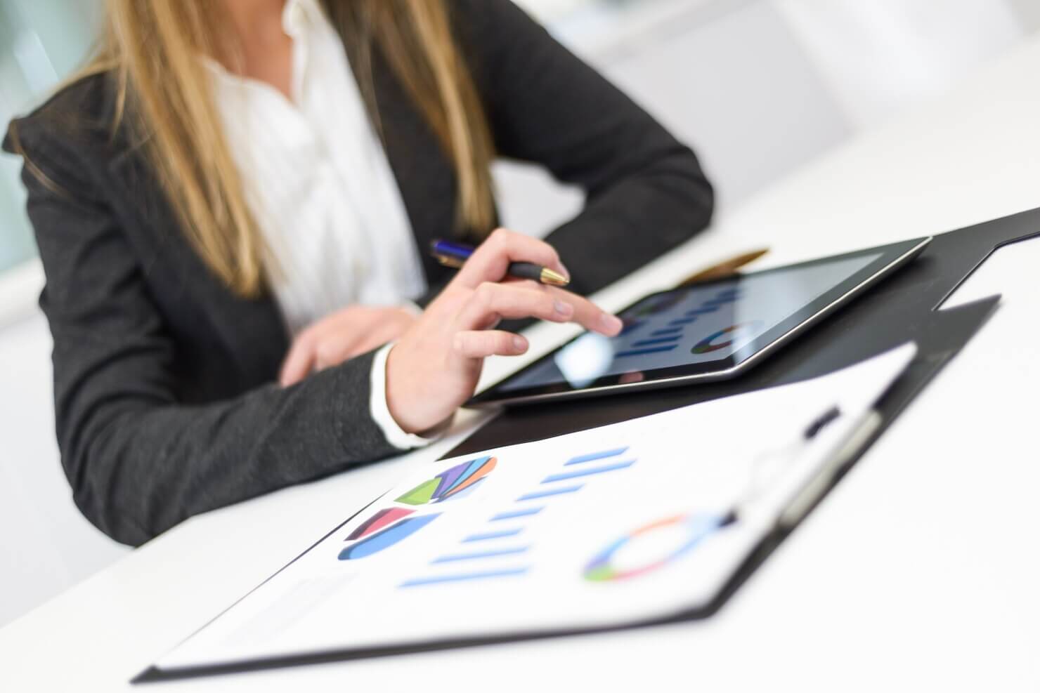 Close-up of businesswoman working with her tablet, review the results of mobile usability audit