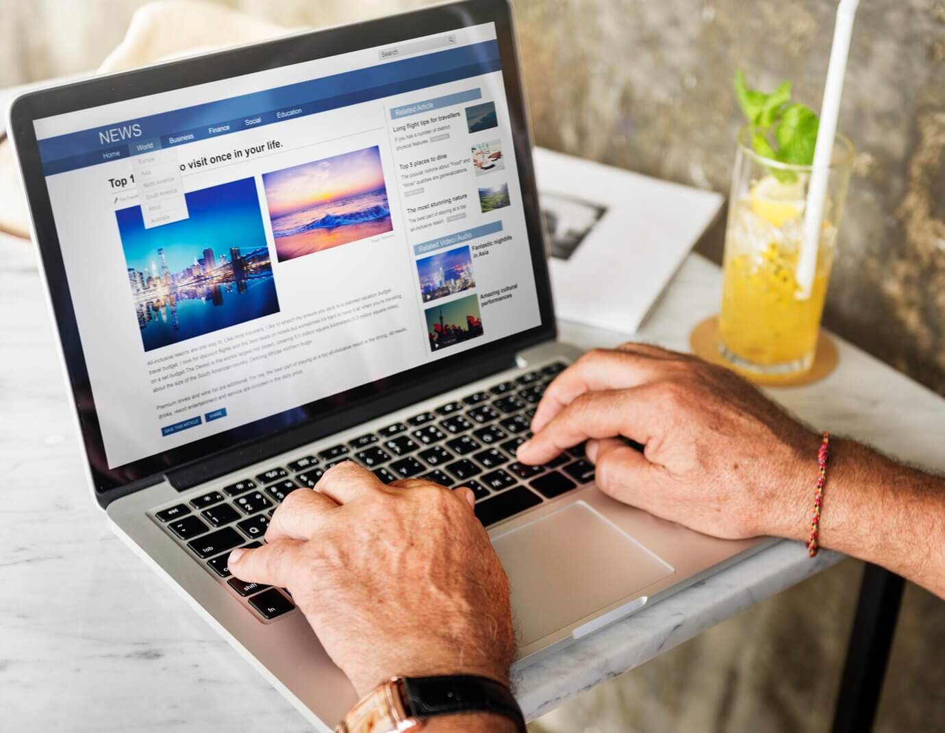 Elderly man is using computer laptop. Exploring news page that makes effective use of images and media to enhance website experience
