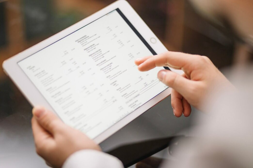 Employee using tablet to verify WooCommerce shop launch checklist