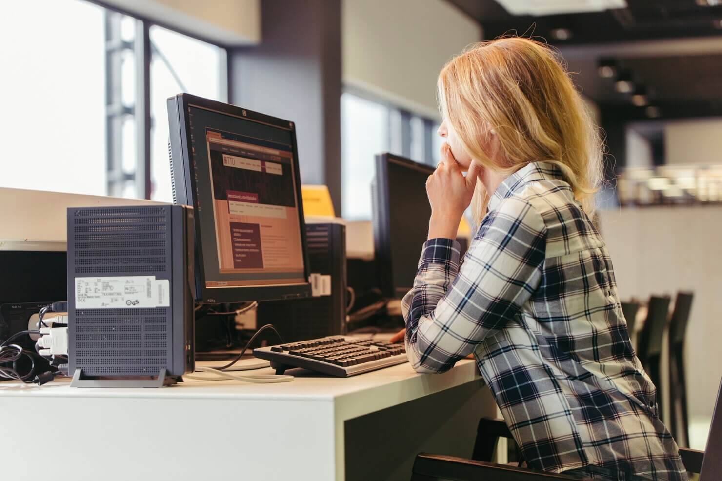 Female developer looking over a WordPress support ticket before closing it after the appropriate resolution