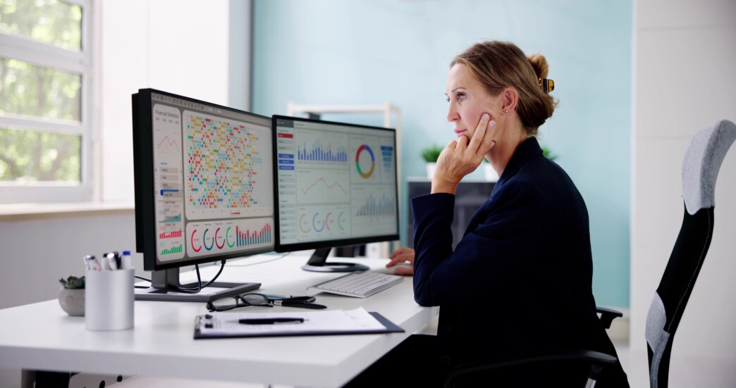Female looking at heatmaps on her computer and analyzing results