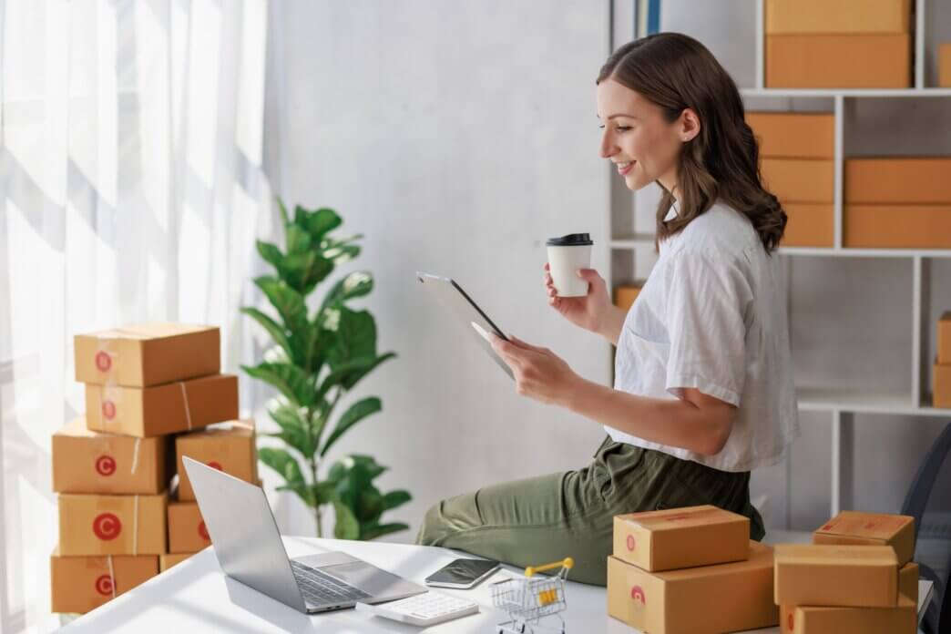 Female reading on tablet about optimizing WooCommerce for bulk orders and wholesale
