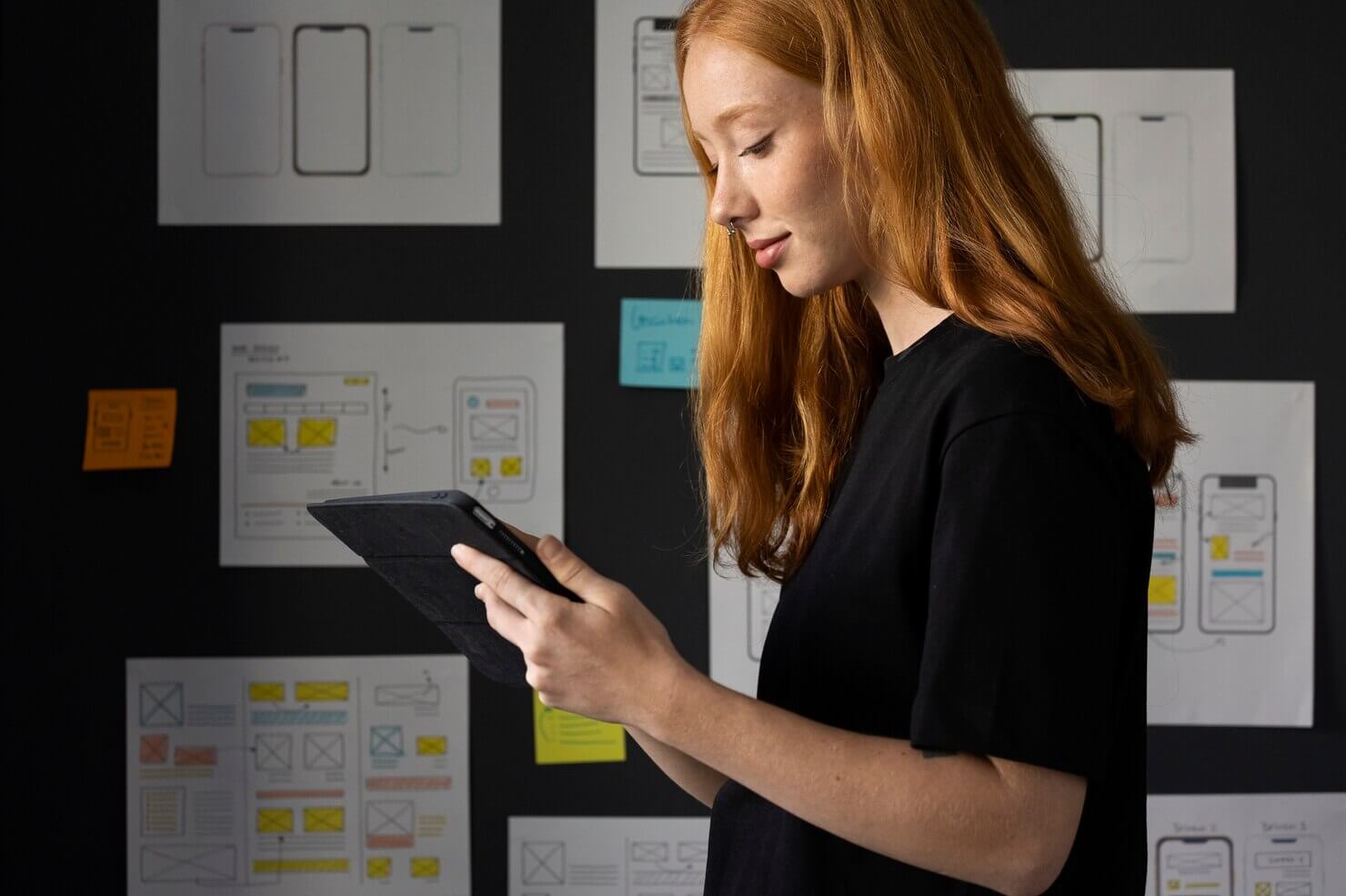 Female web designer in the office with notebook. She is explore UX design options for her website. Neglecting UX testing is a website audit mistakes