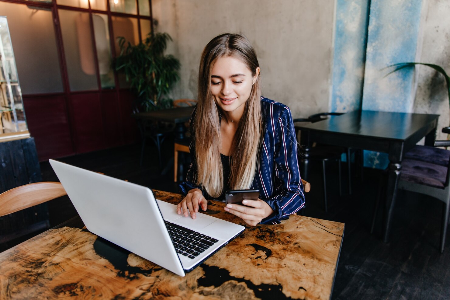 Female working remotely creating a report about Unlimited Support to resotre crashed site and benefit website visitors