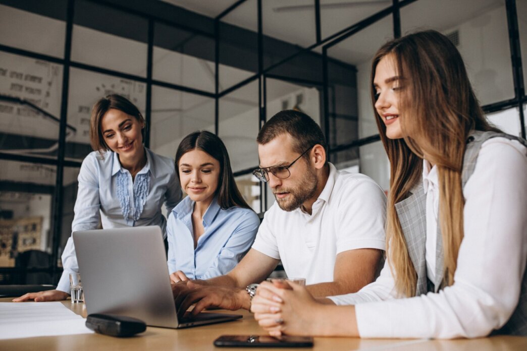 Group of people working out business plan in an office to remedy outsourcing WordPress challenges