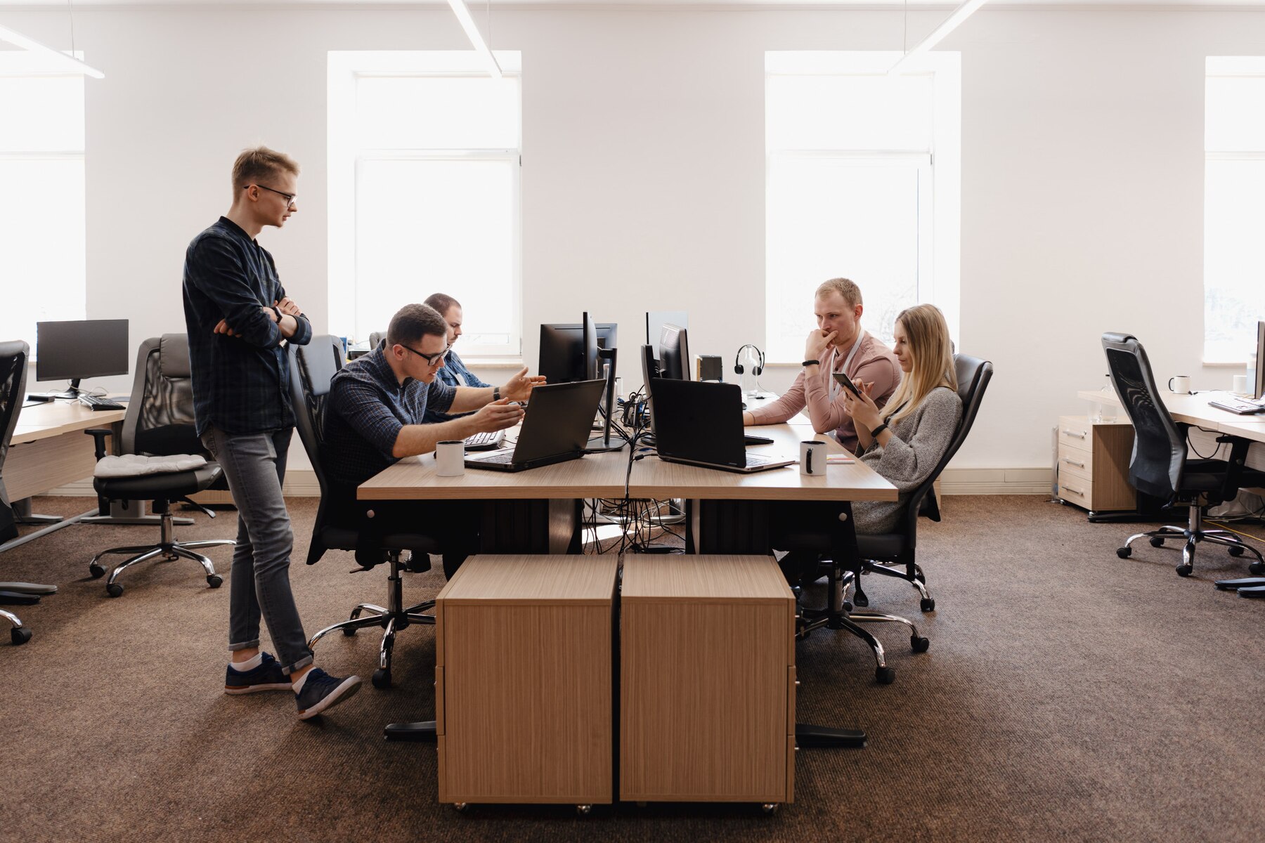 Group of young business people working in the office. They are an outsourcing WordPress development team