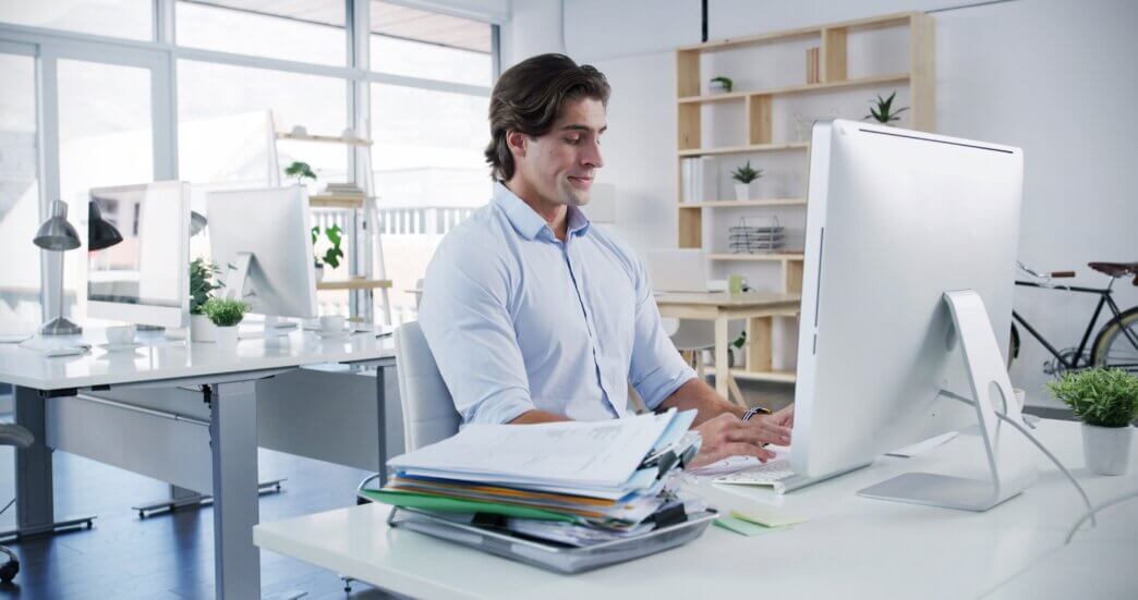 Male business owner looking at research to learn the difference between technical audits vs full website audits