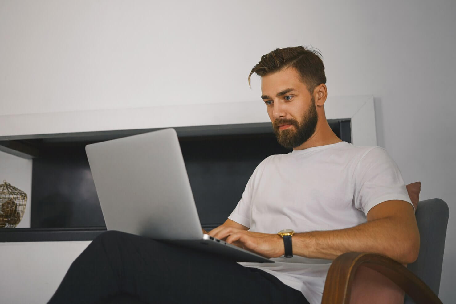 Man doing research on laptop about unlimited support vs hourly WooCommerce help
