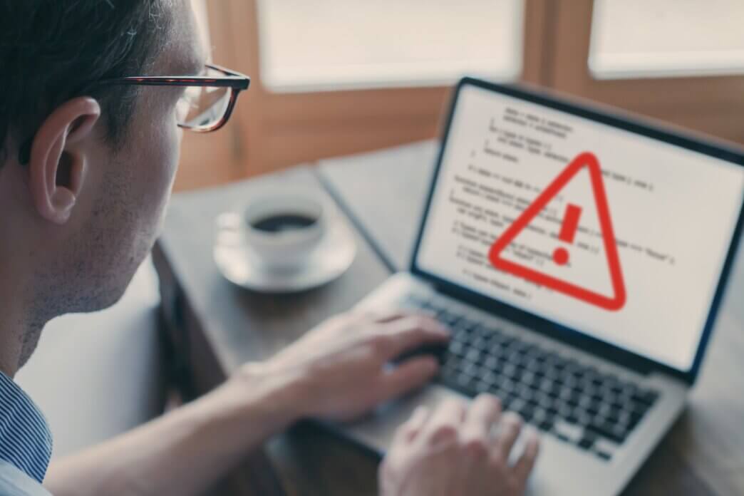 Man experiences error on his computer as he is working on code. Common signs you need WordPress support services