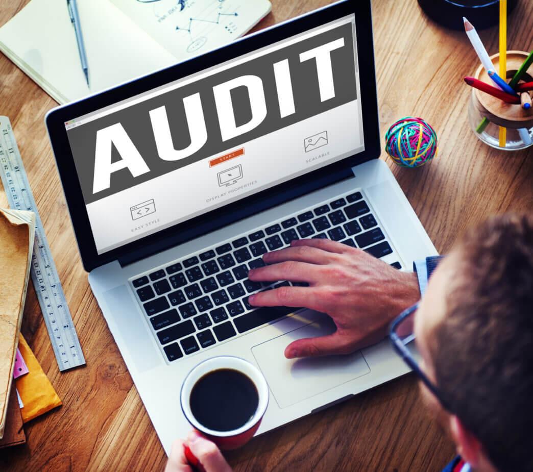 Man exploring automated vs manual website audits on his laptop