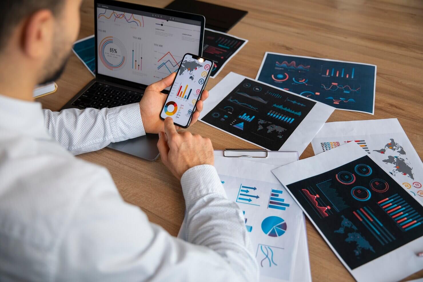 Man looking over various website audits for ongoing WordPress development