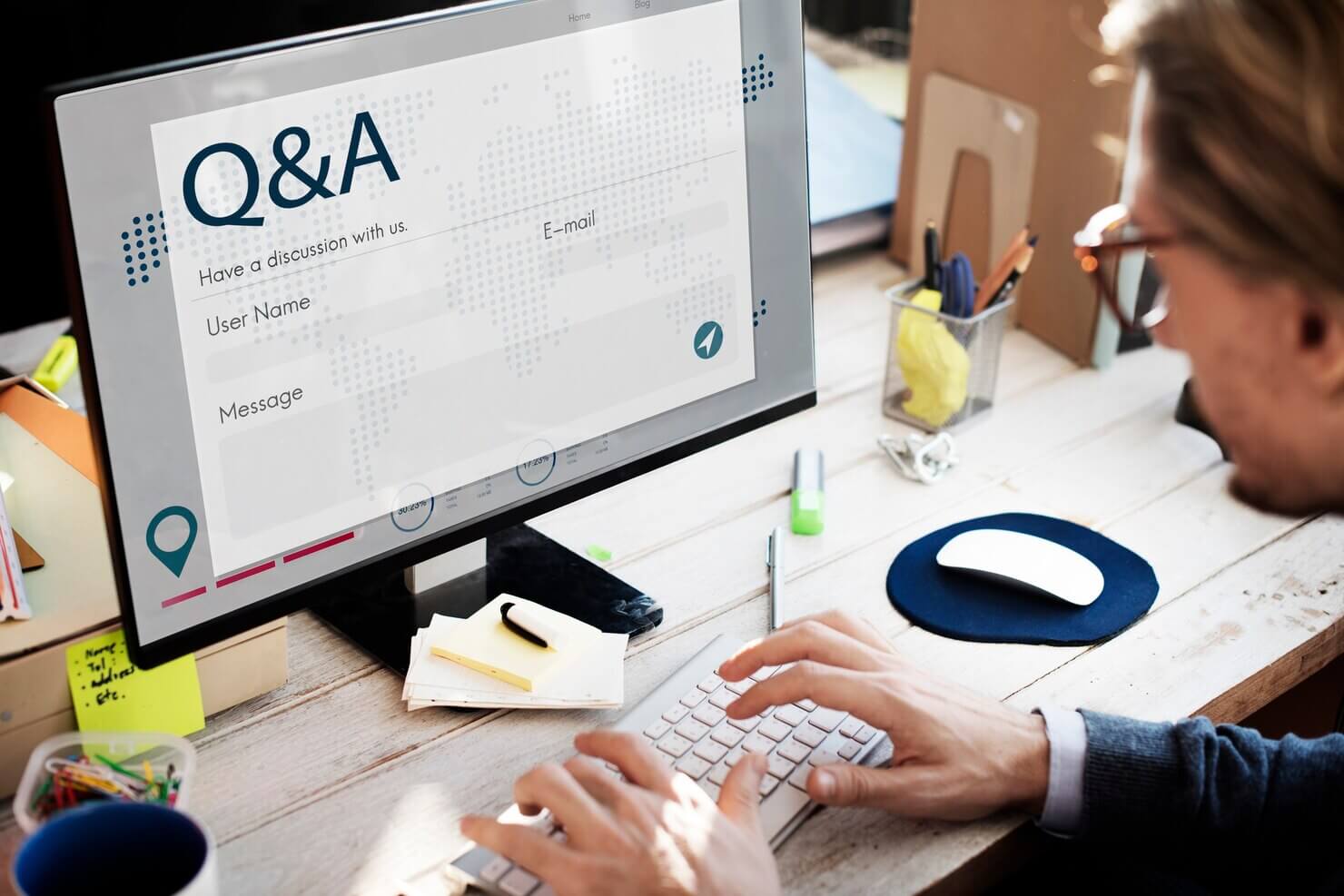 Man setting up FAQs on website for local voice search queries