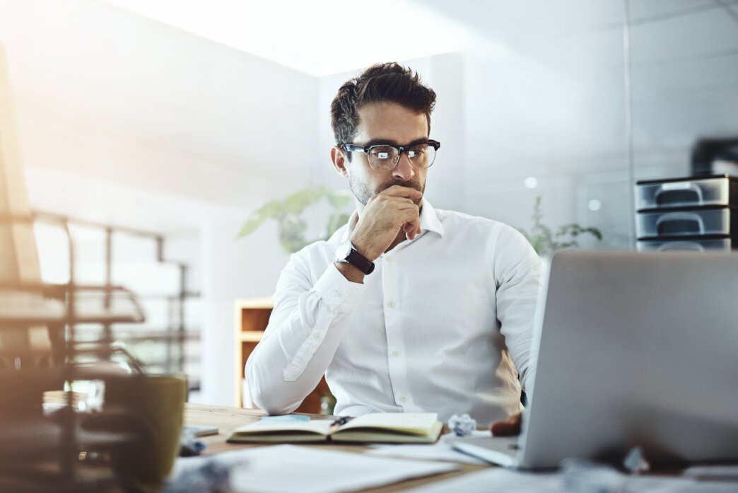 Man working on his laptop to create a WordPress disaster recovery plan