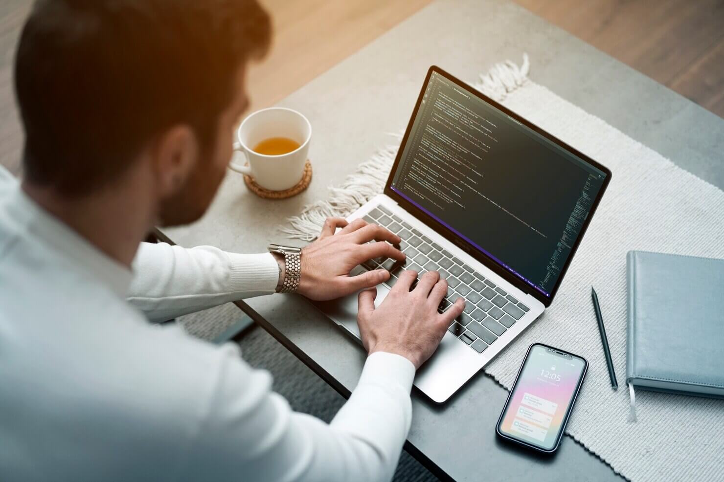 Medium shot man working on laptop. WordPress outsourcing to scale your business