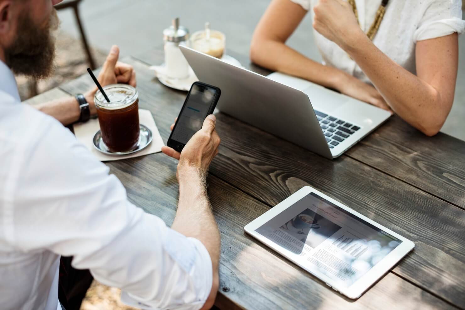 People at coffeeshop looking to optimize WordPress site for mobile SEO