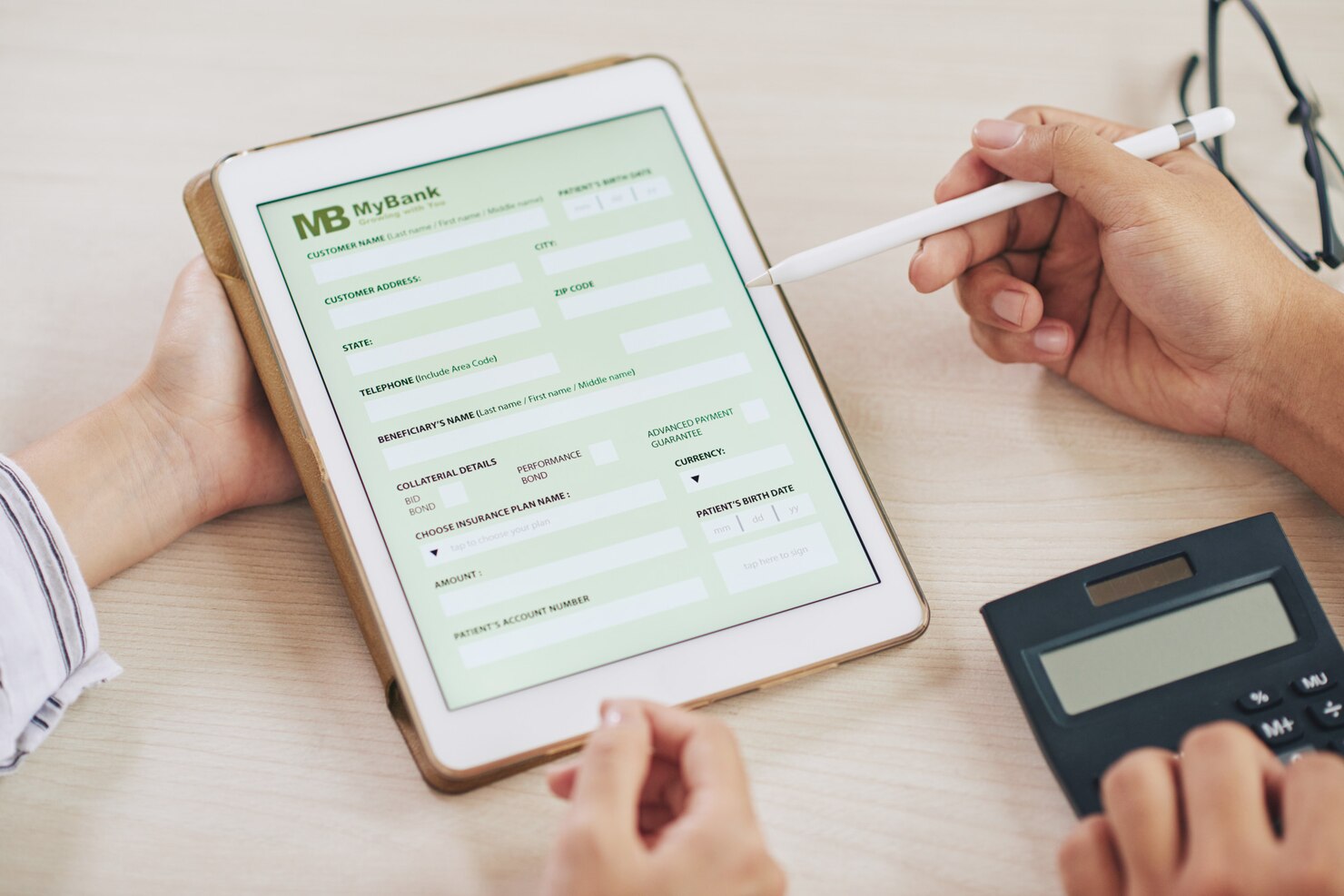 People using tablet with bank app. They are testing out a new form for users
