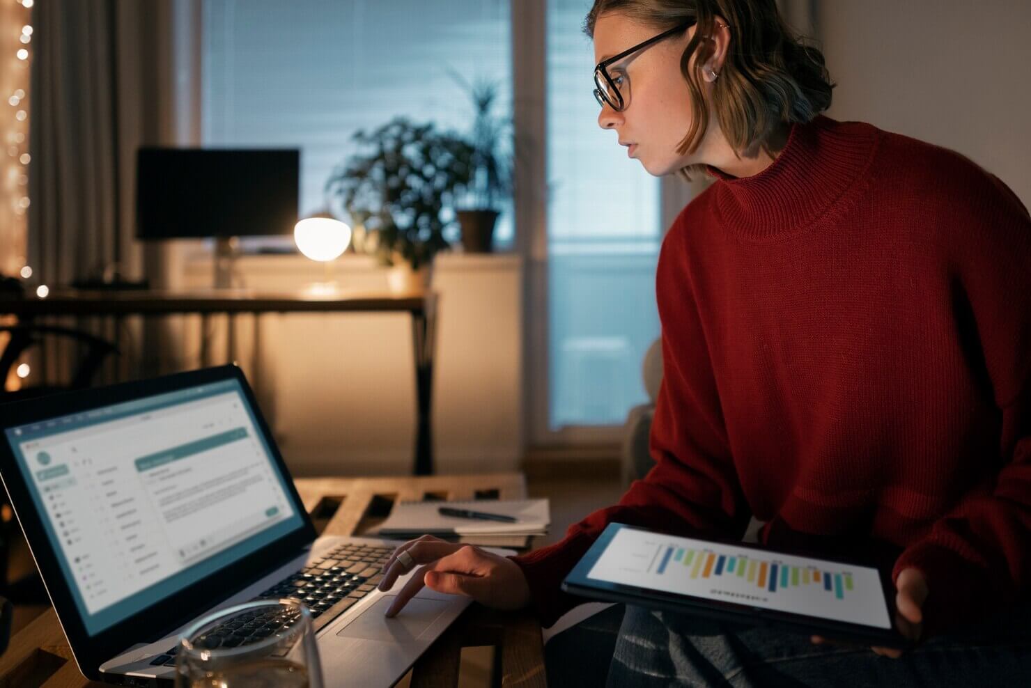 Person at working late at night from home. She is going over Google analytics for her business website