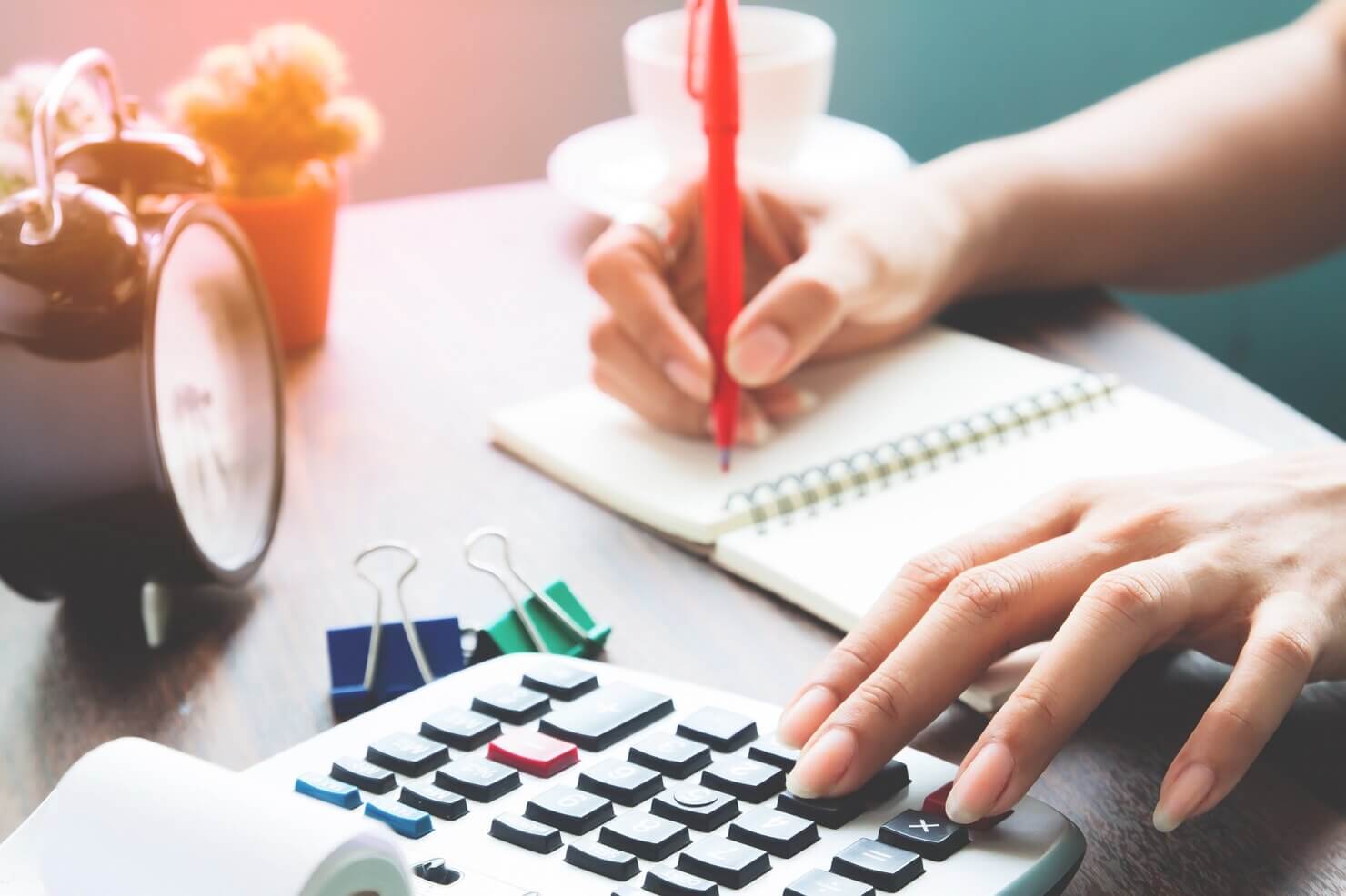 Person calculating cost of web pages on WordPress vs Wix