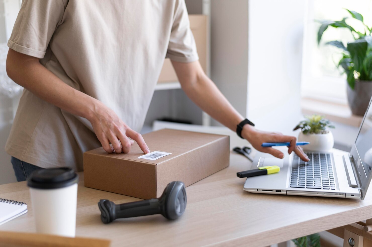 Person checking inventory with order. Person about to ship out a box. eCommerce support could have helped with inventory numbers