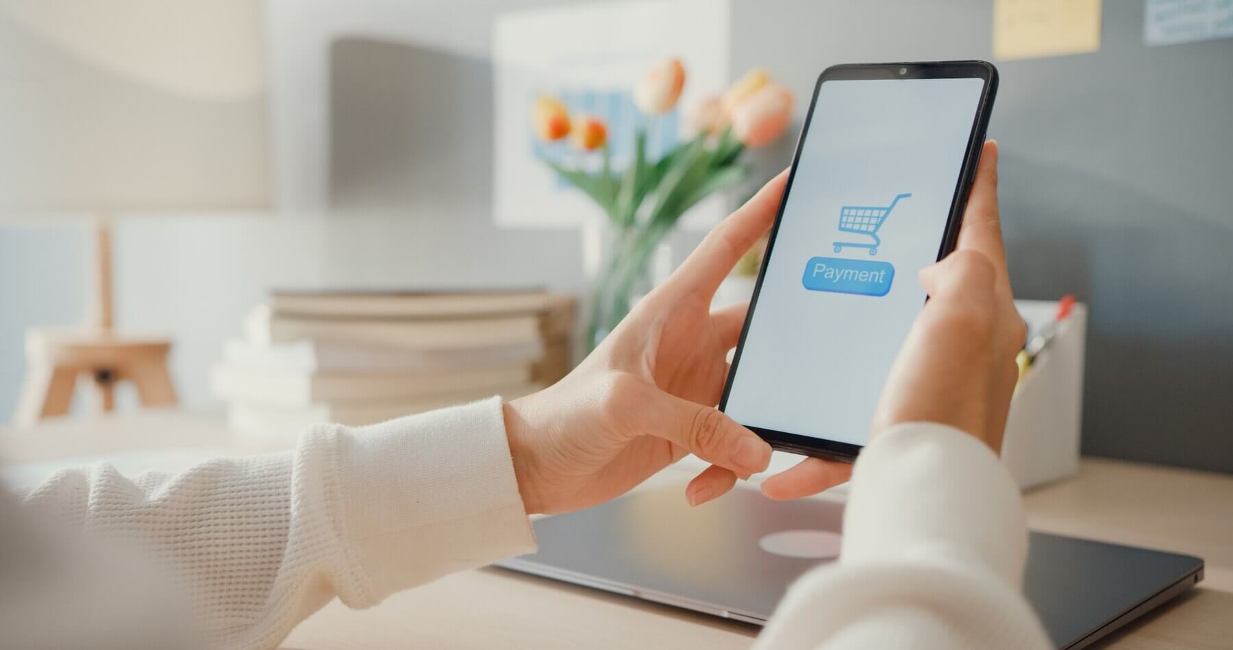 Person paying with cellphone online shop, without abandoning cart
