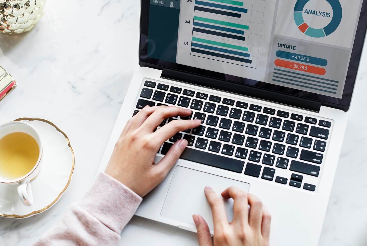 Person using laptop to look over the website audit results for her website