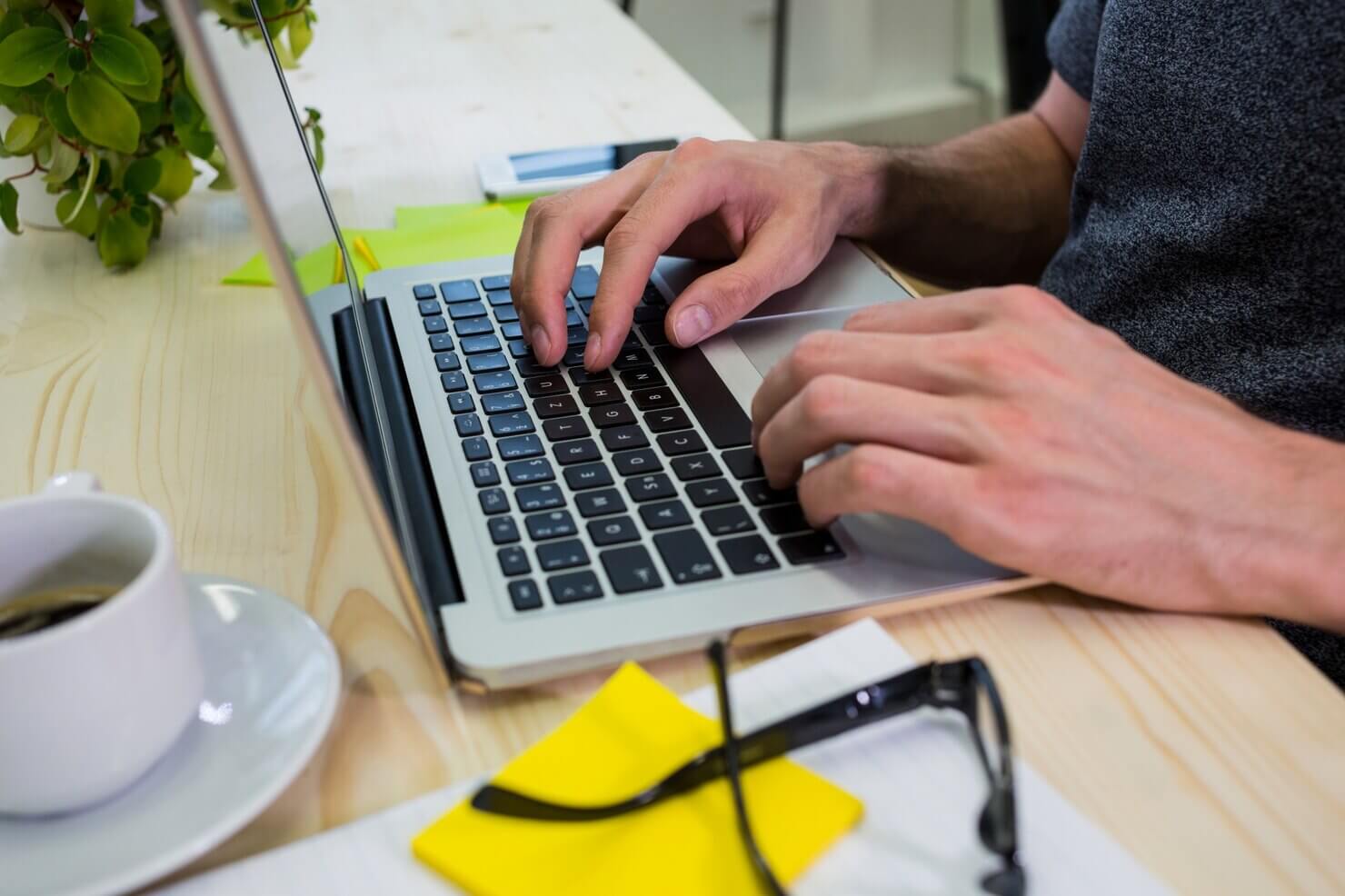 Person working with a laptop looking through plugins for long-form content