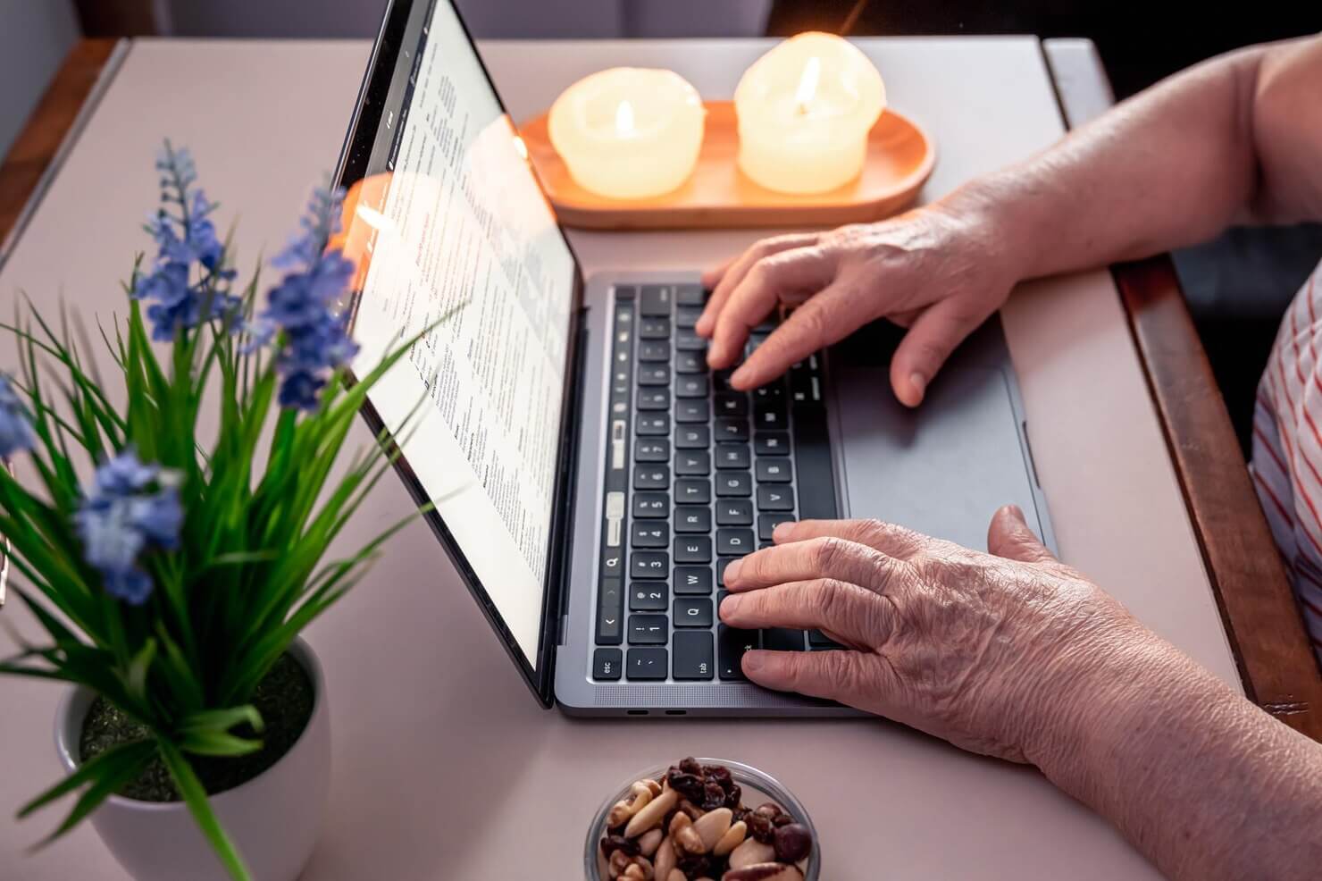 Retired woman uses laptop hands close up. Website is accessibile. Accessibility compliance tested via technical audits vs full website audits