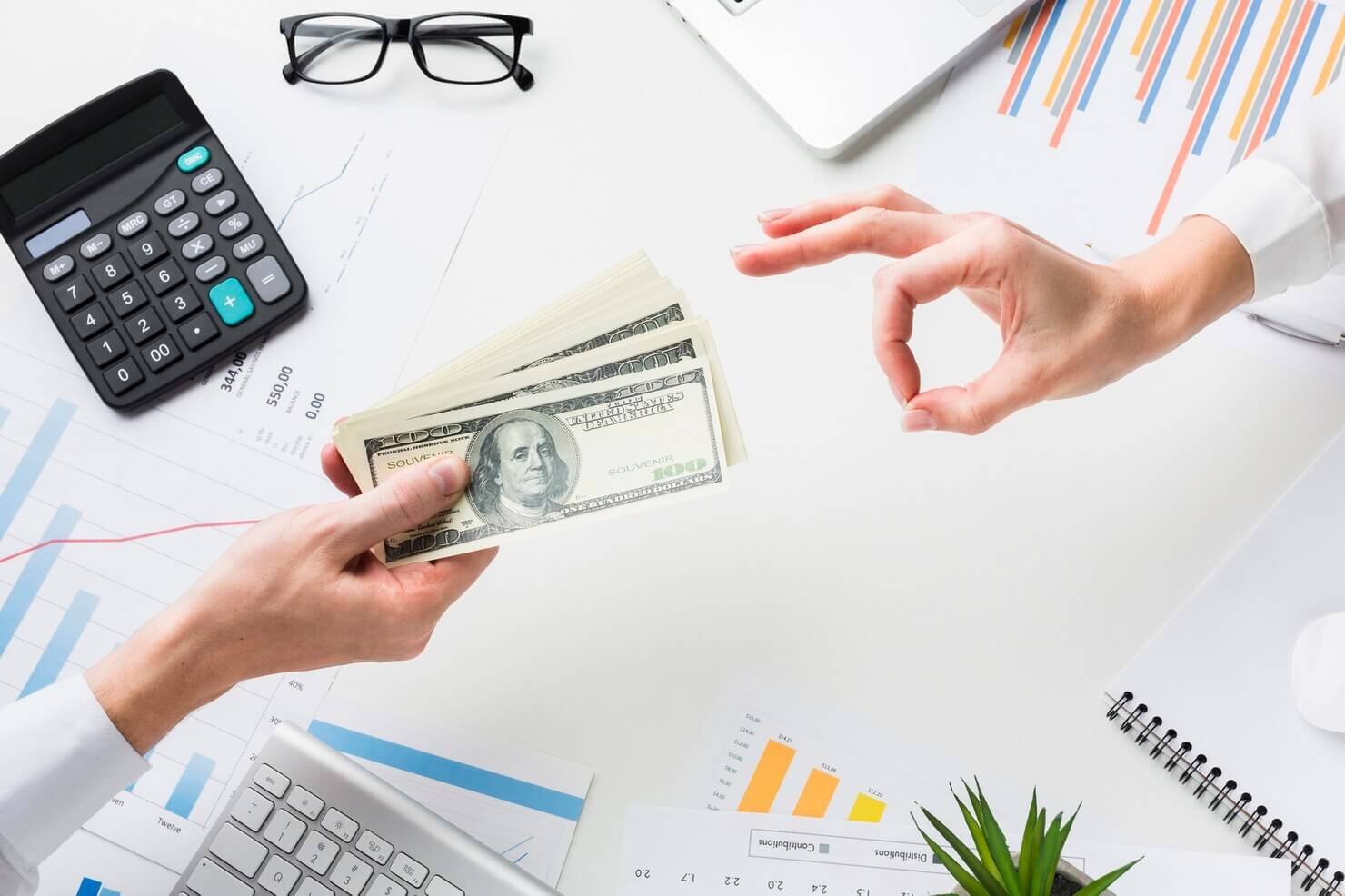 Top view of hand accepting money over desk. Wholesale sales with a refund and return. Wholesale prices premium. Optimizing Woocommerce for bulk orders and wholesale