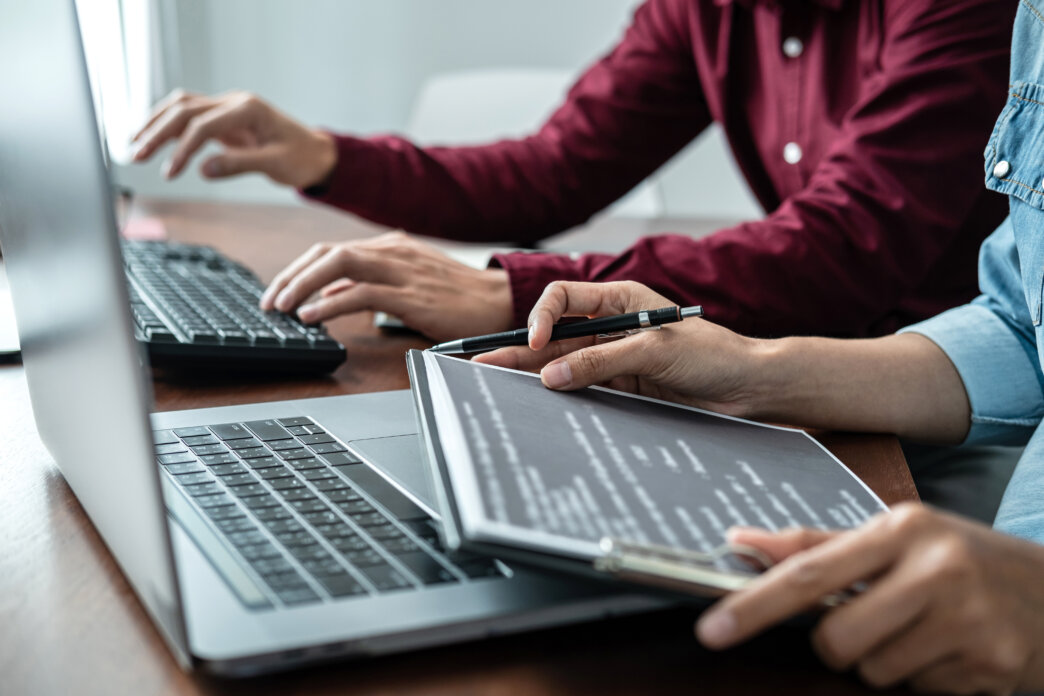 Two people running a WordPress security audit