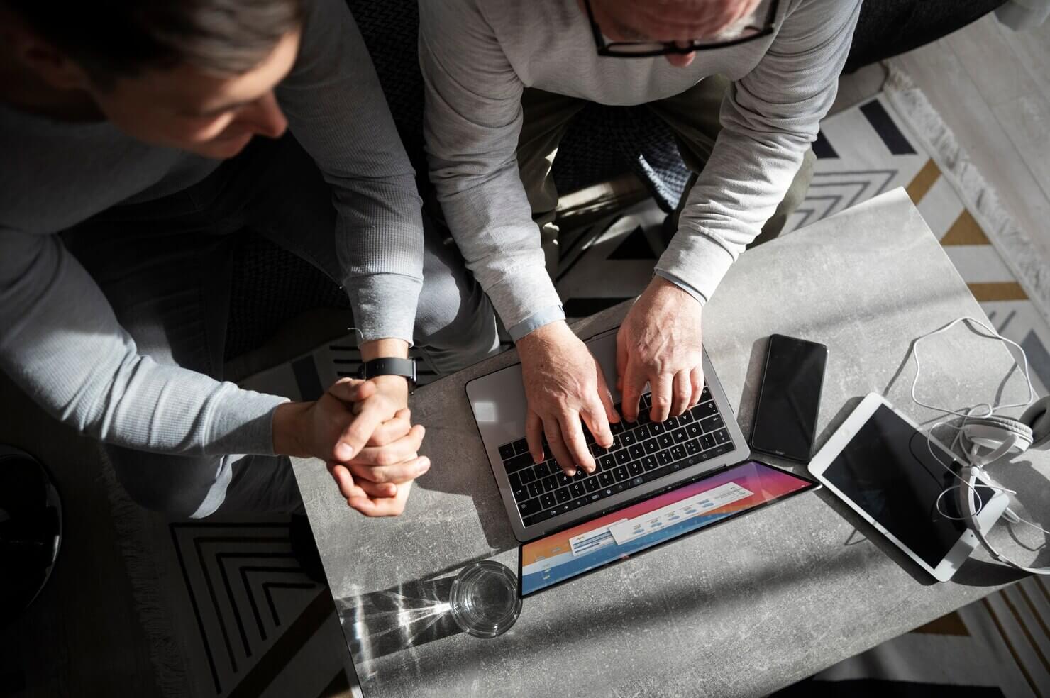 Two people using Figma on a laptop