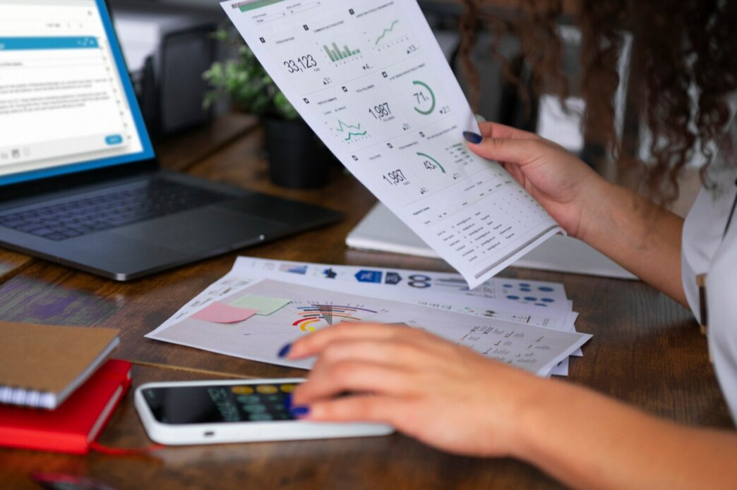 Woman calculating how to optimize a wordpress landing page for paid traffic