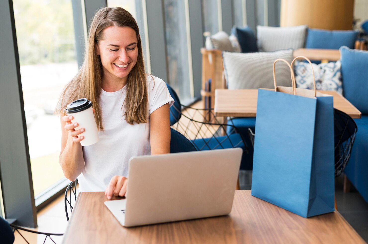 Woman in a cafe ordering products online