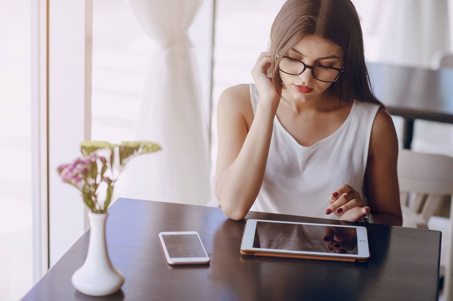 Woman looking at tablet, evaluating checklist for security audit