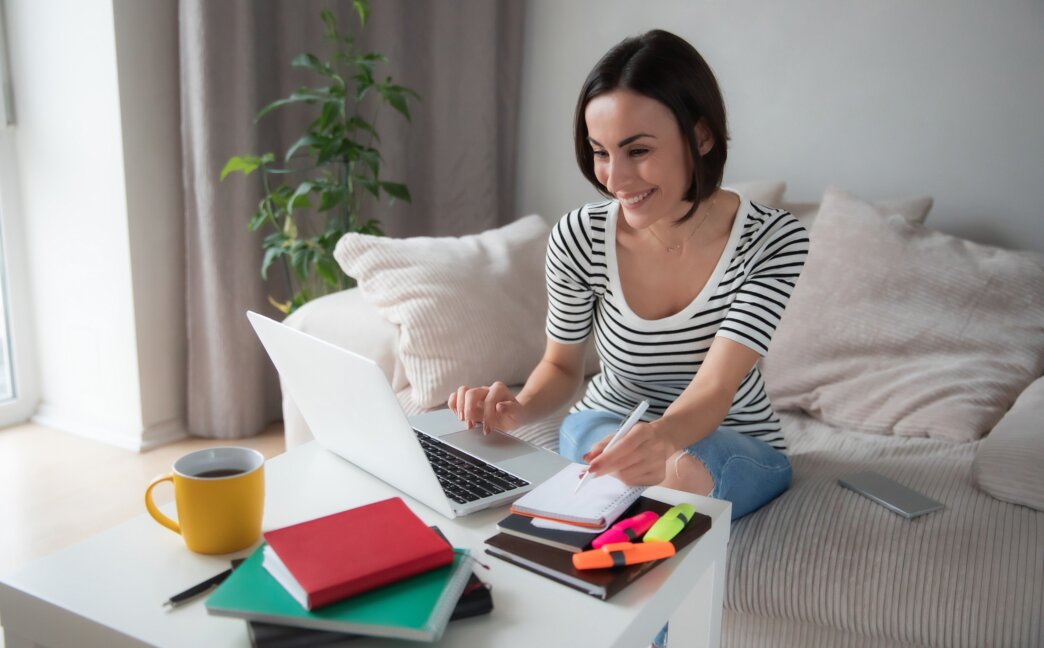 Woman managing user roles and permissions on her website using laptop. Working from home