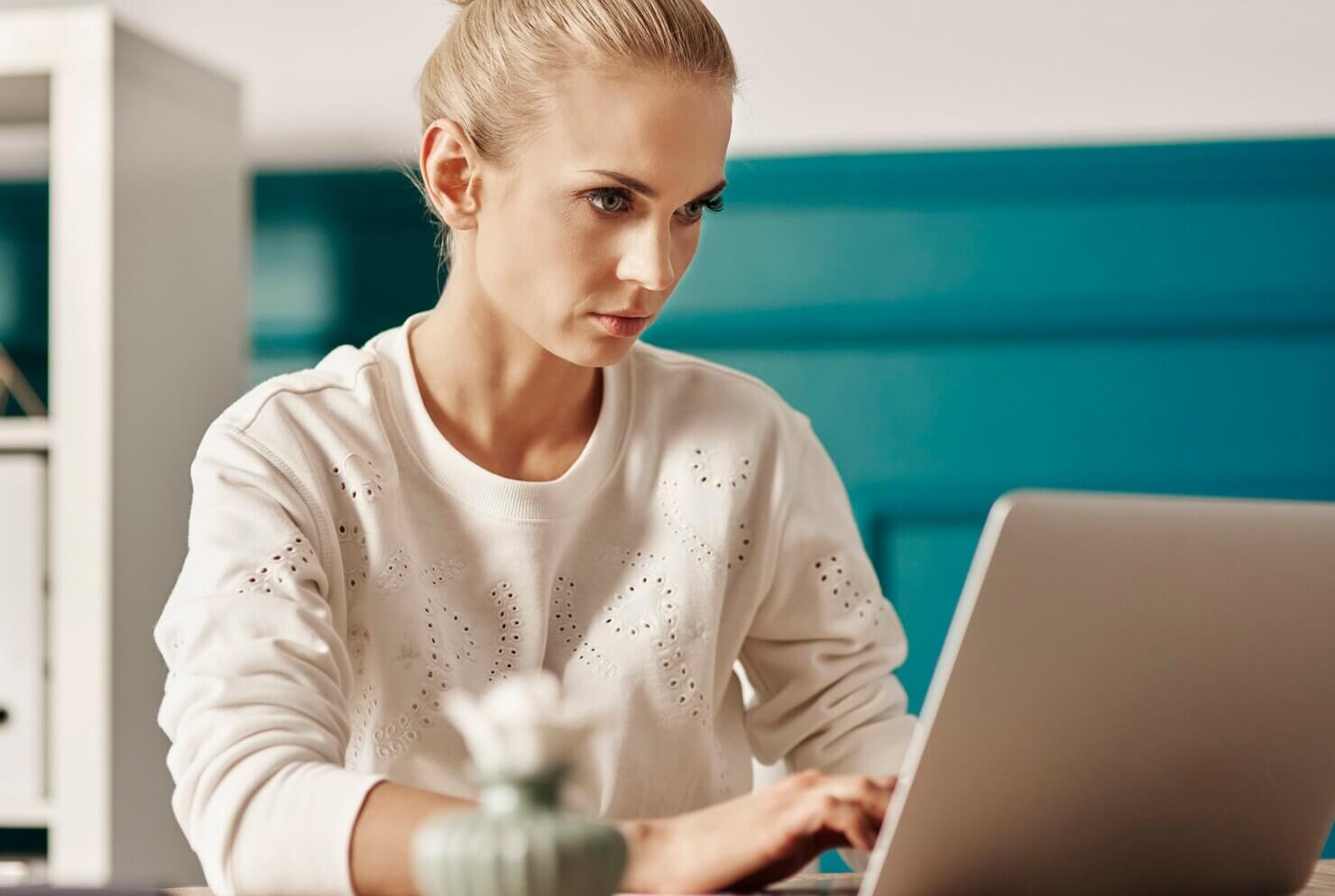 Woman researching which CMS platform to use