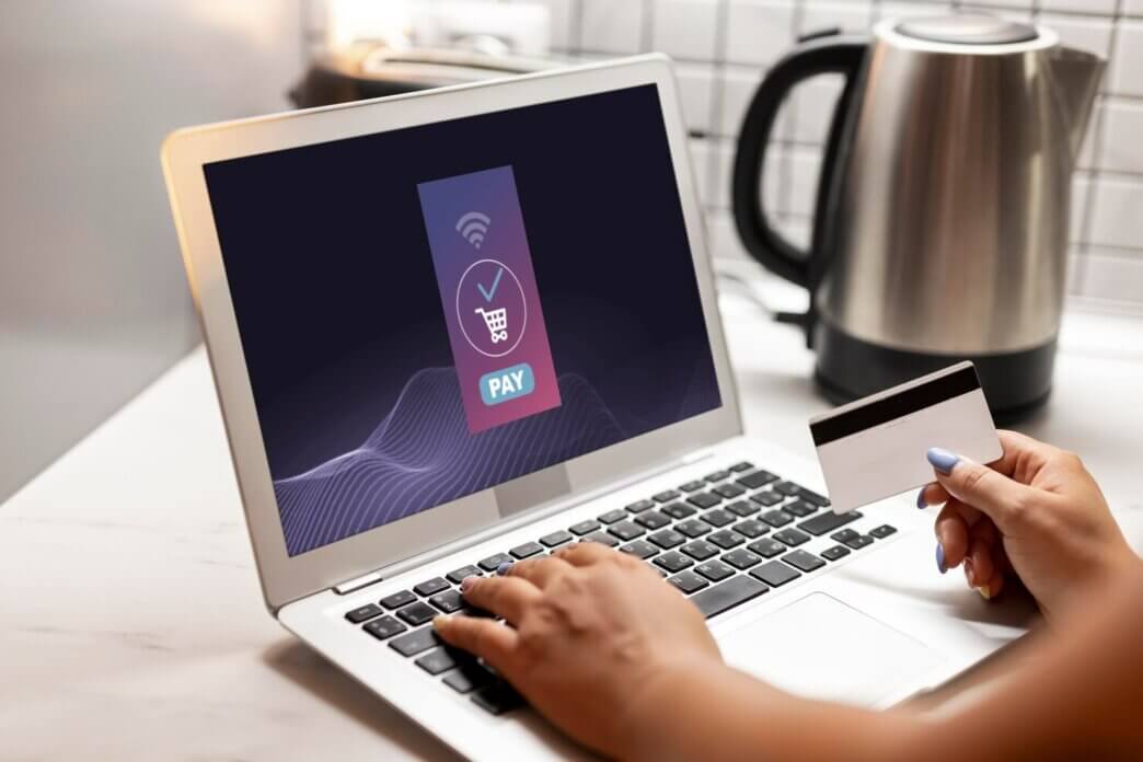Woman using laptop for online shopping with credit card. Accessibility boosts sales in WooCommerce store