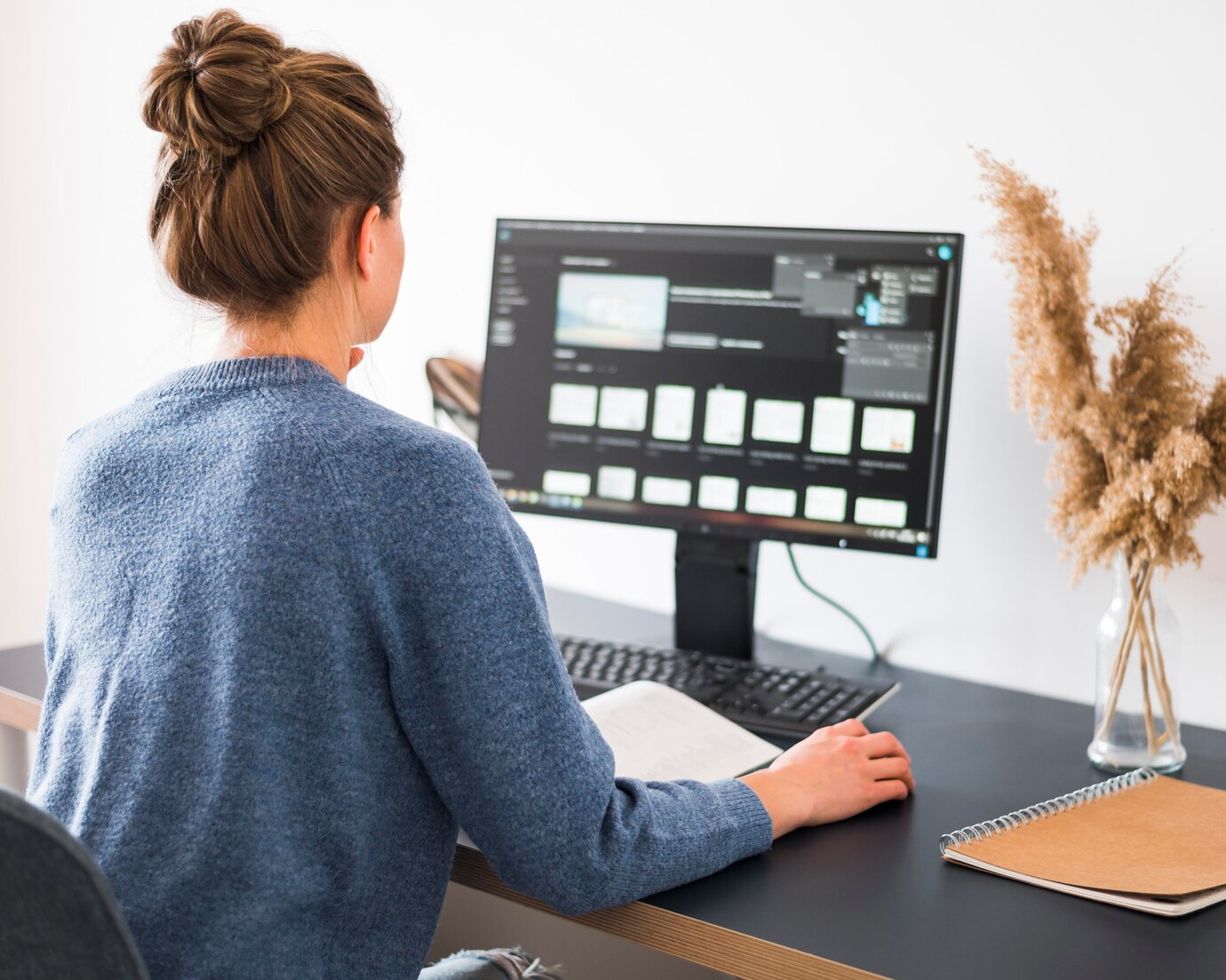 Woman working at desk on WordPress support services and eCommerce site support for membership sites