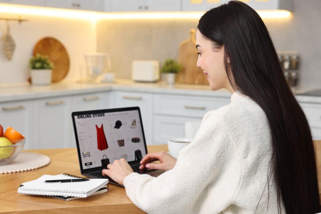 Woman working on her online shop. She is also looking to avoid mistakes in WooCommerce store with unlimited support