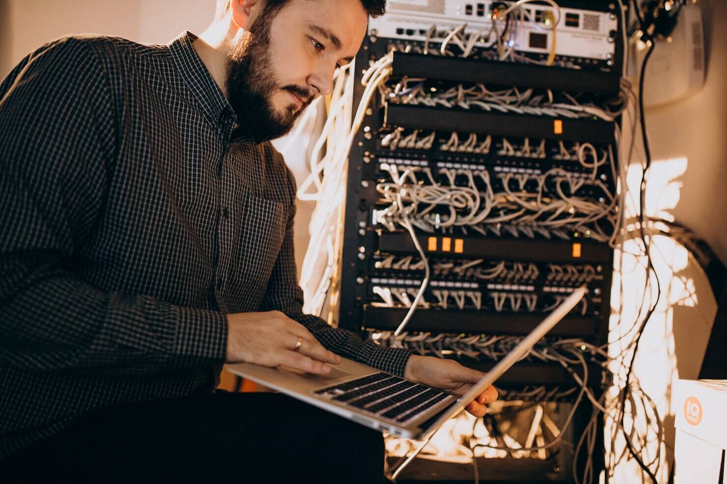 Young it service man repairing computer and server due to performance issues