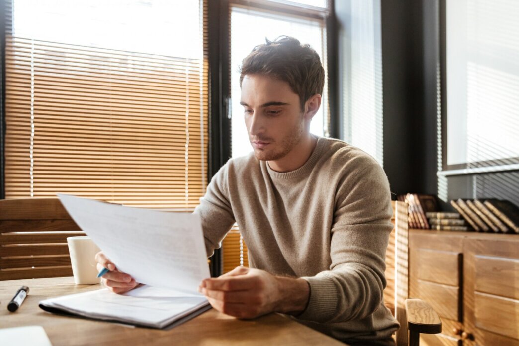 Young man reading how successfully carry out Outsourcing WordPress Projects
