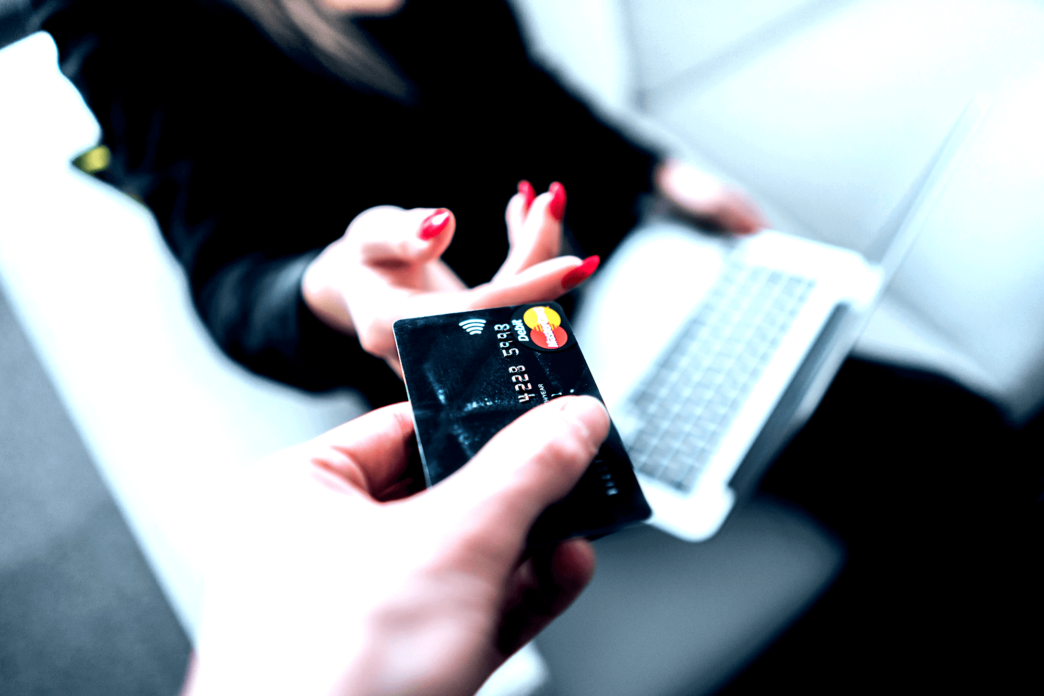 Man is giving his credit card to a woman for the online shopping